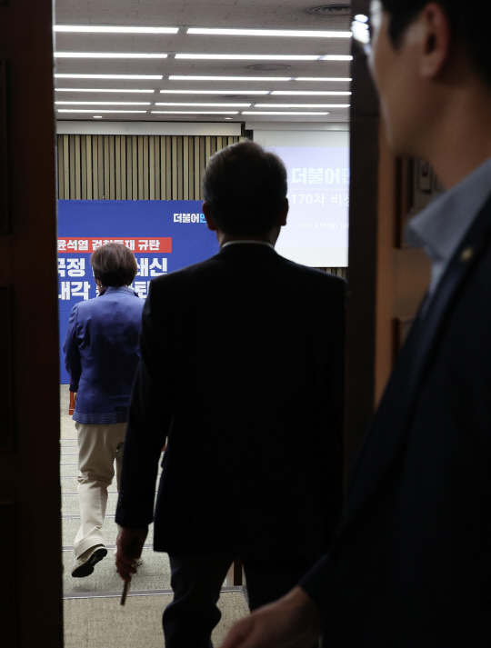 더불어민주당 의원들이 18일 국회에서 비공개로 열리는 의원총회에 입장하고 있다. 연합뉴스.